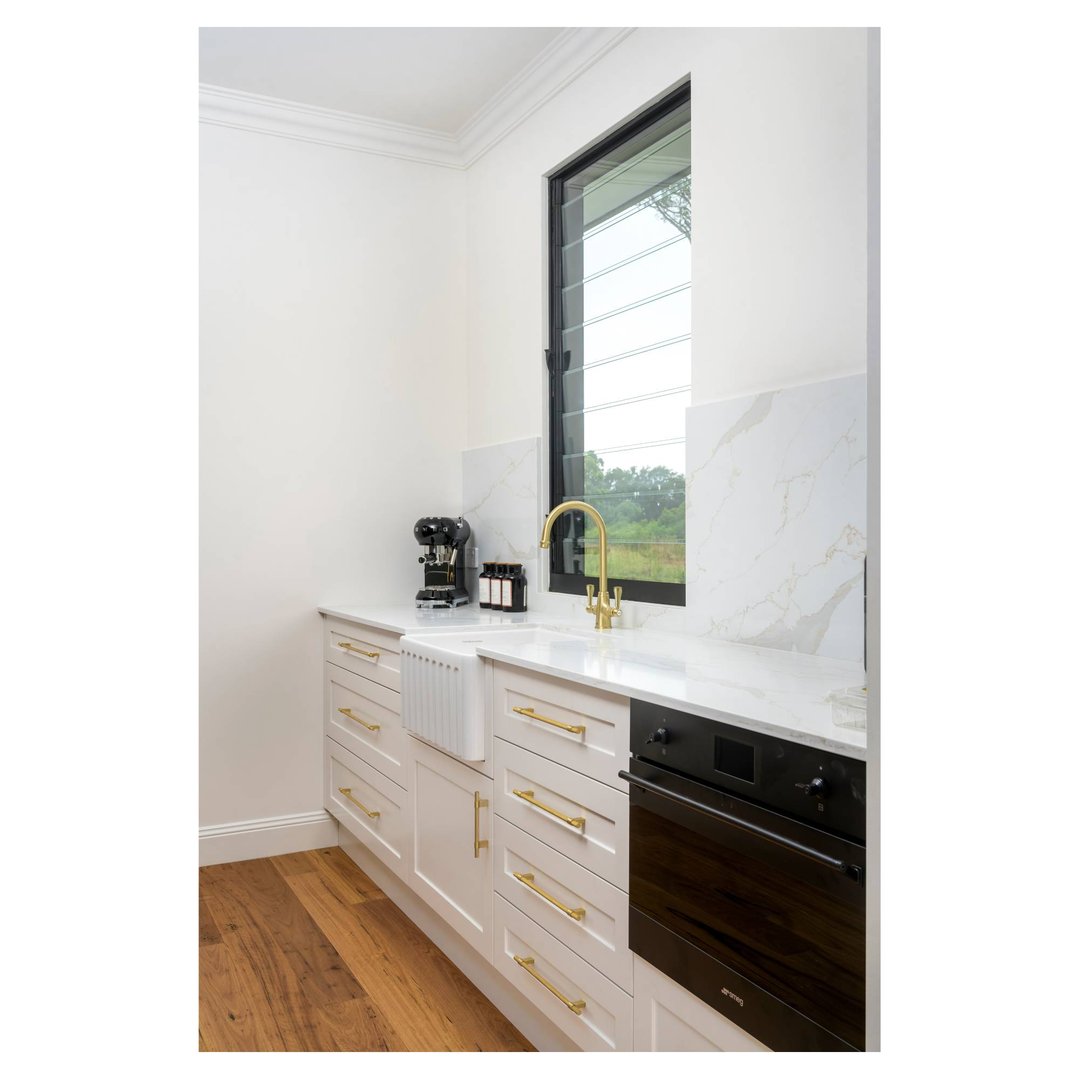 Brushed brass Ludlow Purifier Mixer with filter cartridge in a modern kitchen