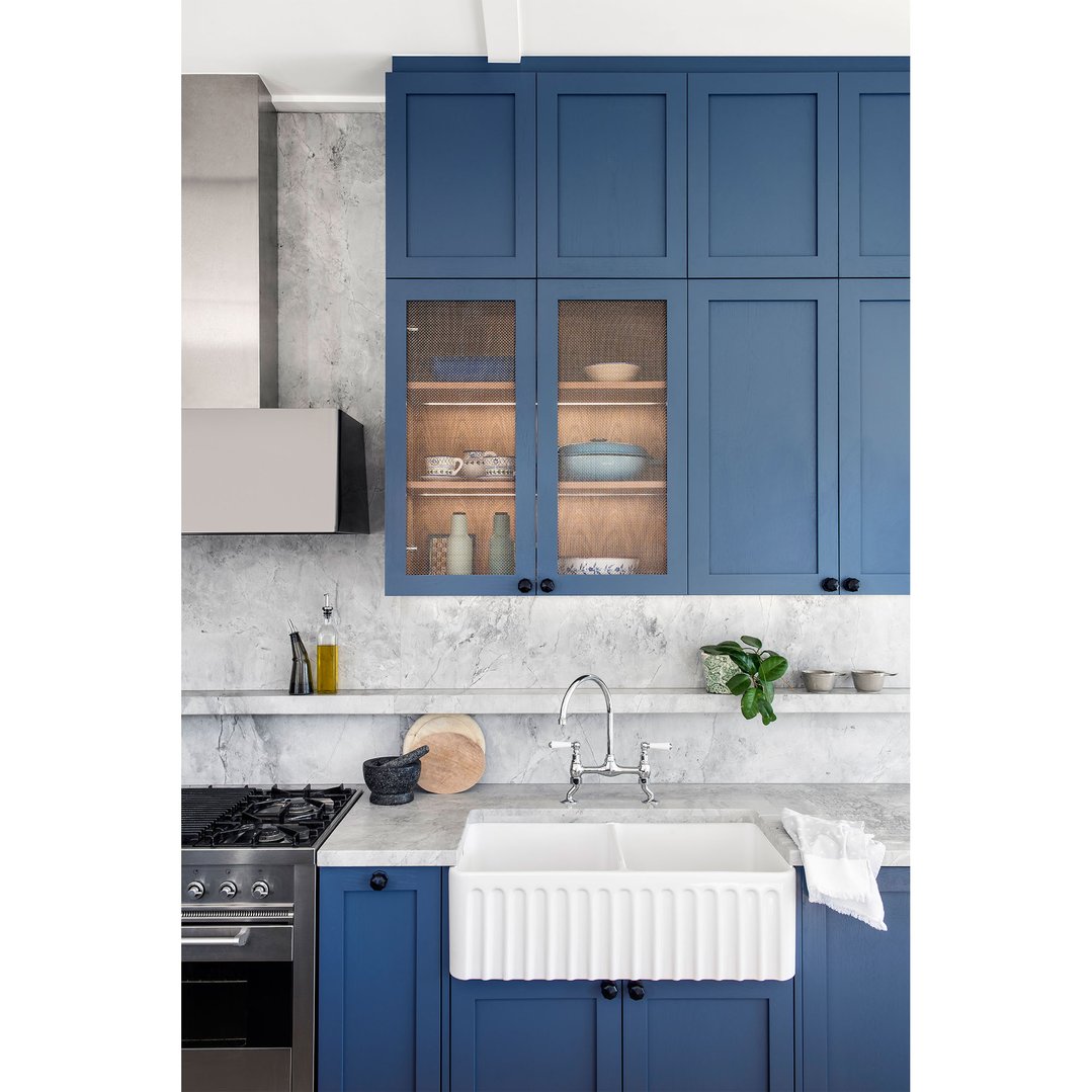 Novi double bowl fireclay butler sink in a blue and white kitchen