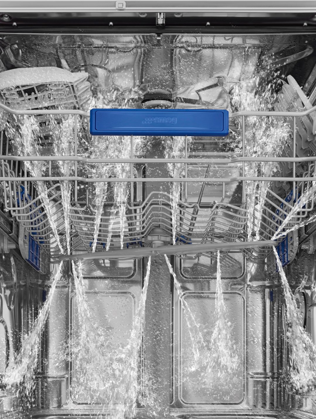 Inside a dishwasher with water spraying during a wash cycle