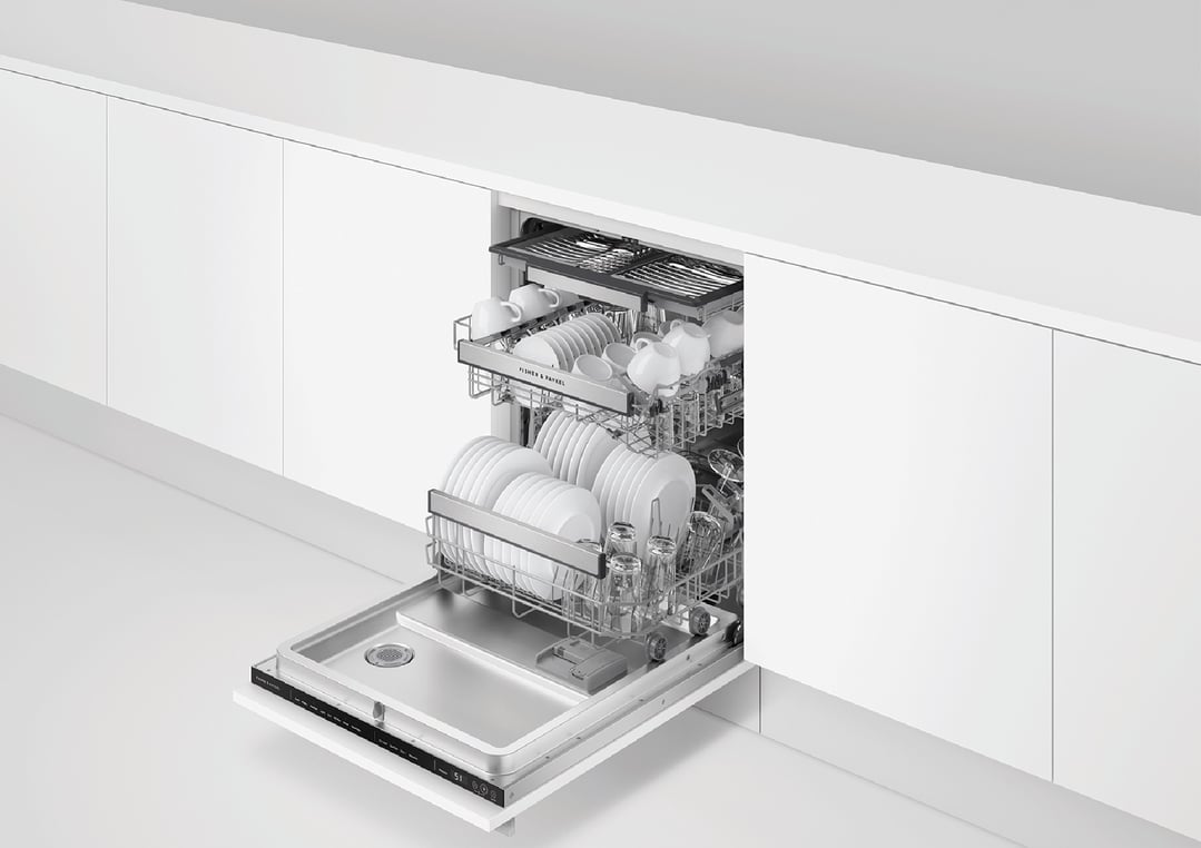 Integrated dishwasher with door open, showing racks filled with white dishes and glasses