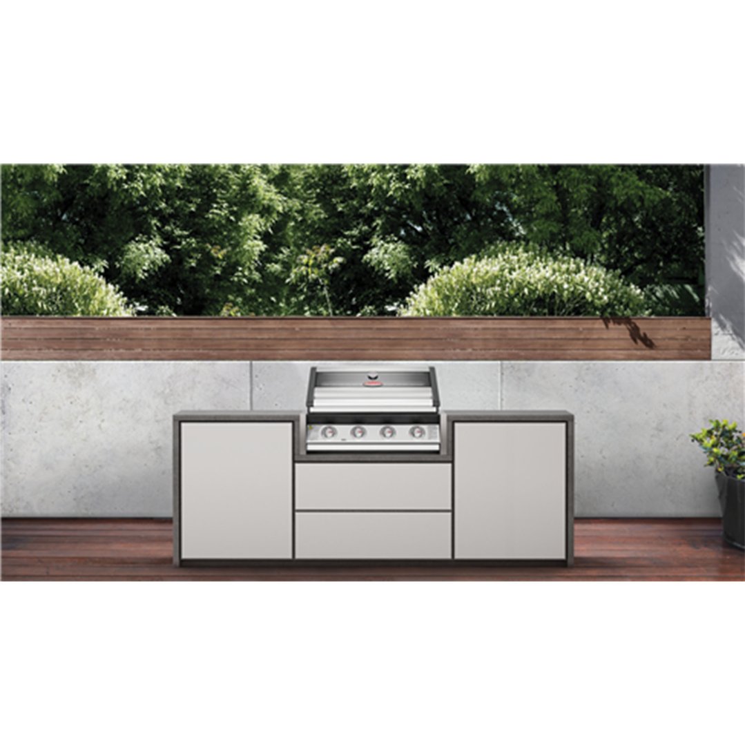 Built-in Beefeater 4 burner barbecue in an outdoor kitchen setting with greenery