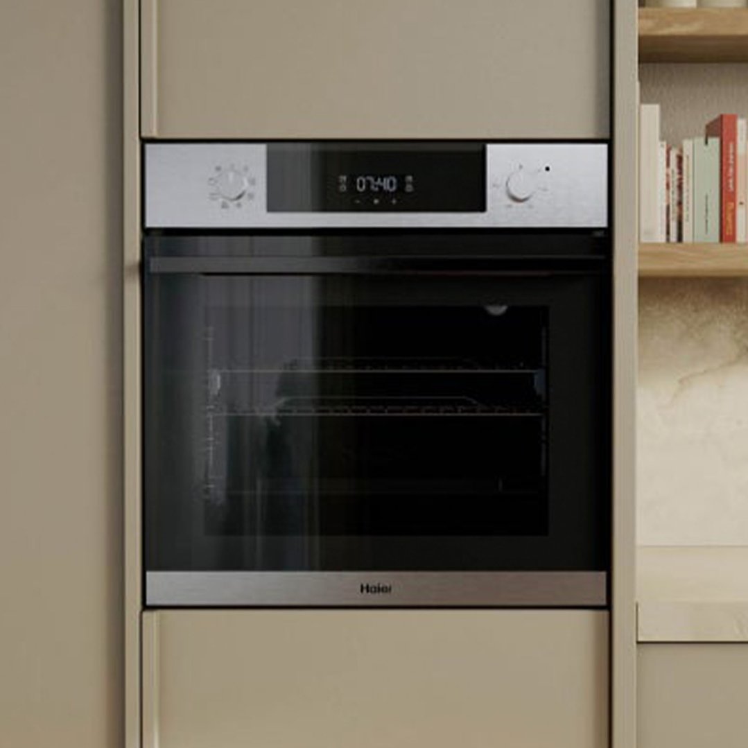 Built-in oven with a digital display and control knobs in a kitchen setting