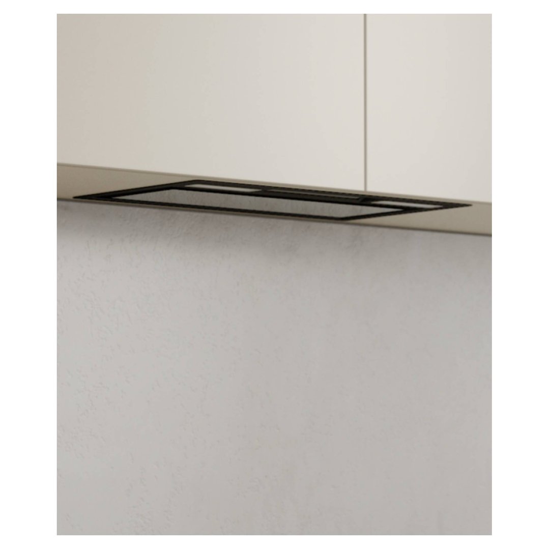 Integrated insert rangehood installed under light-colored kitchen cabinets