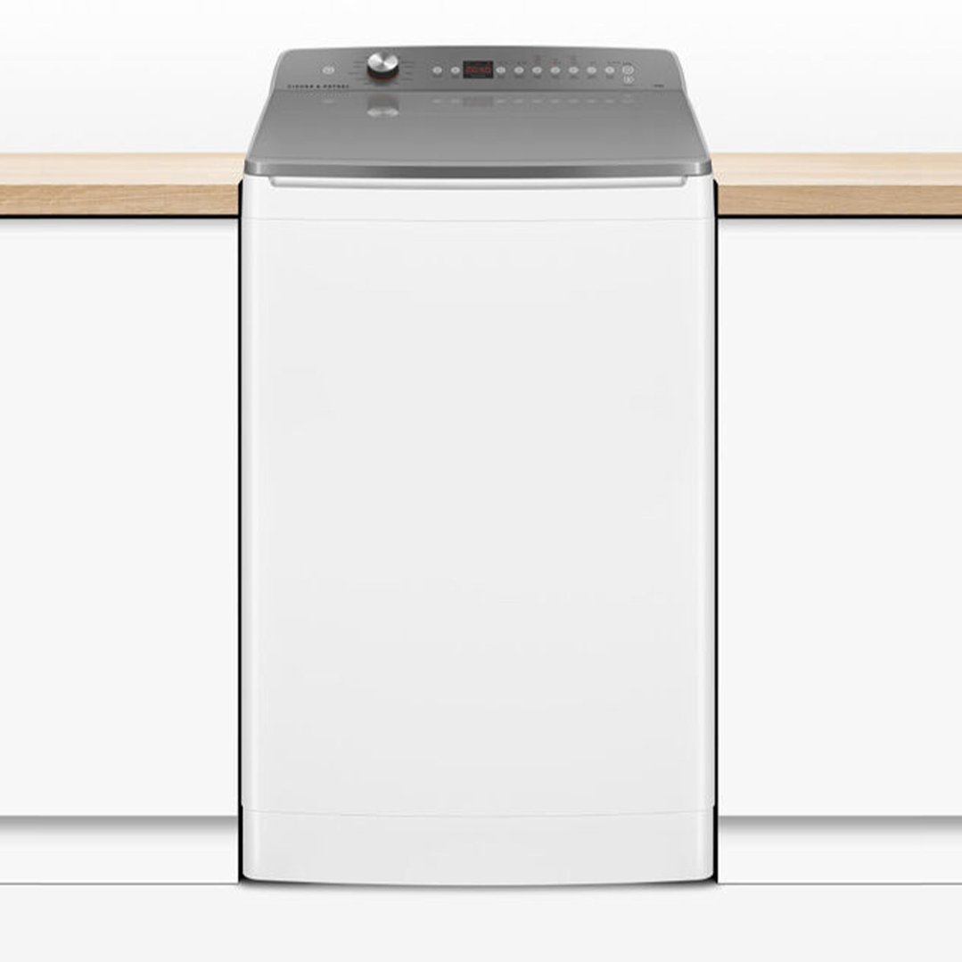 White top loader washing machine integrated into a kitchen counter