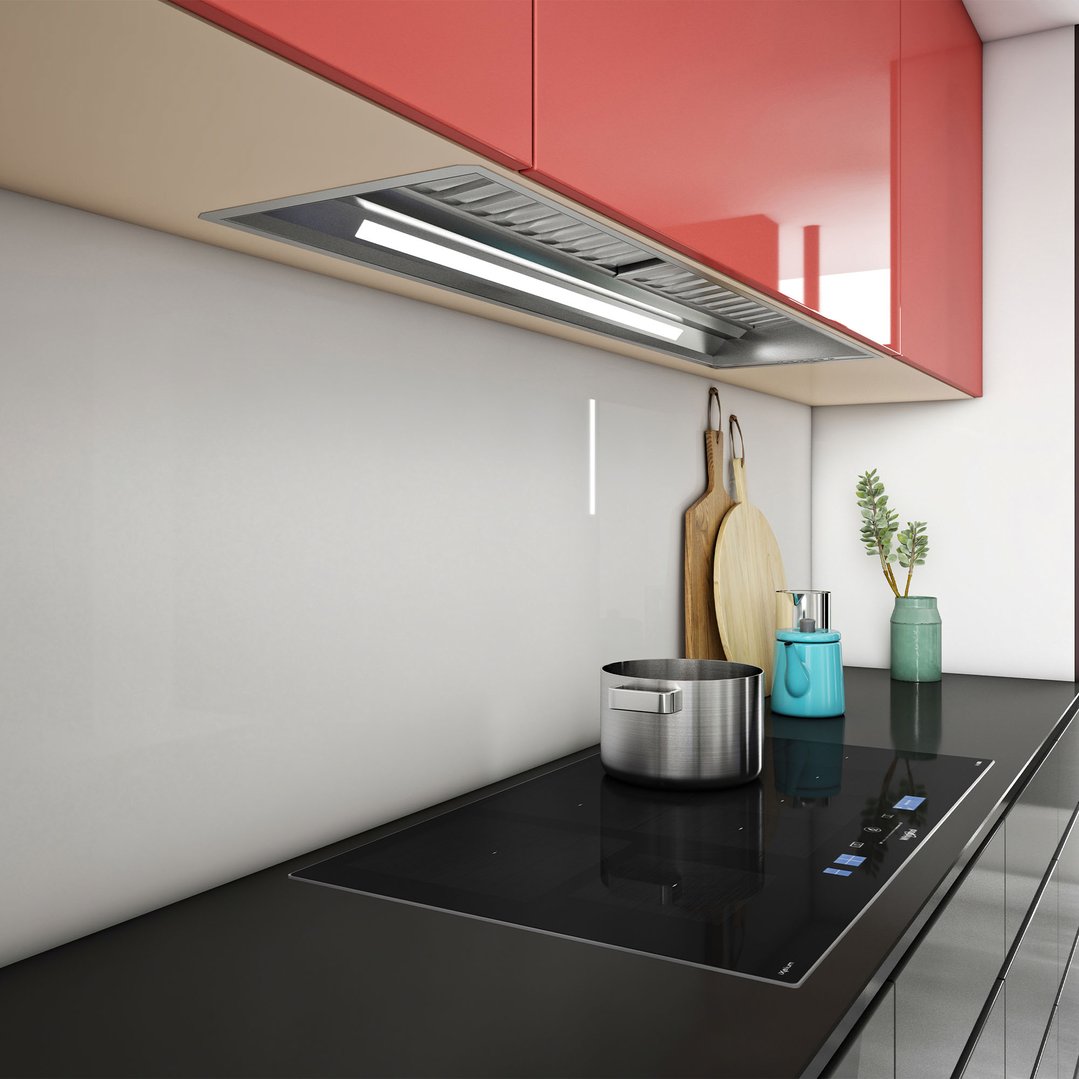 Rangehood installed above a cooktop in a modern kitchen with red cabinets