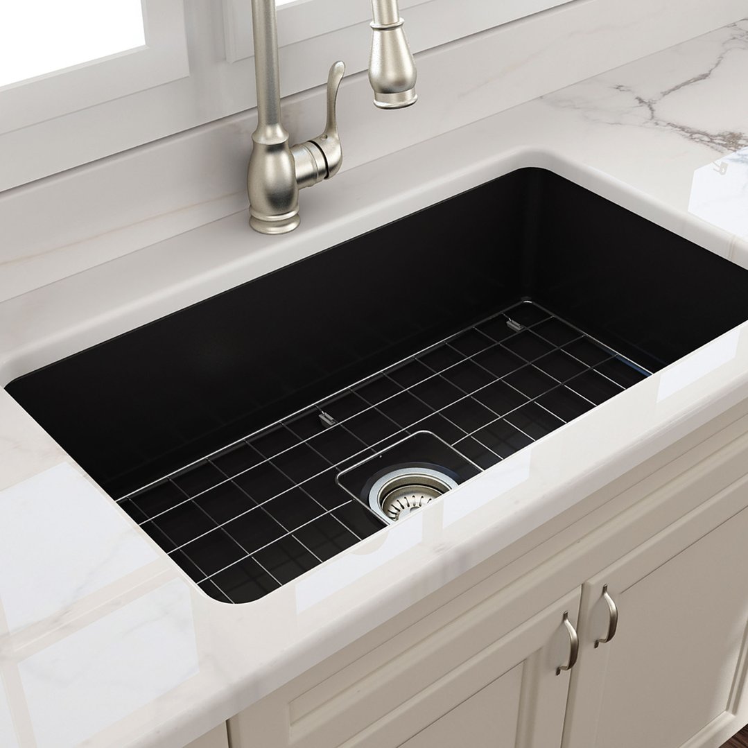 Matte black fireclay sink with a grid in a kitchen setting