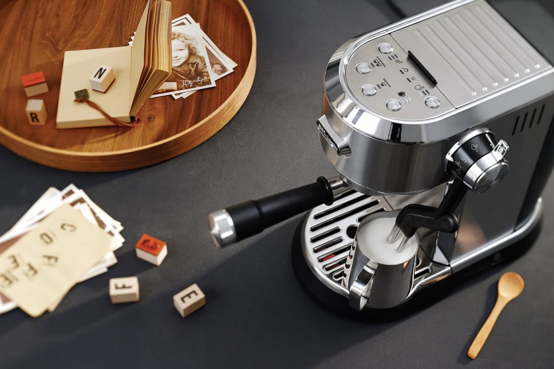 Dedica Maestro Plus Manual Coffee Machine frothing milk in a styled setting