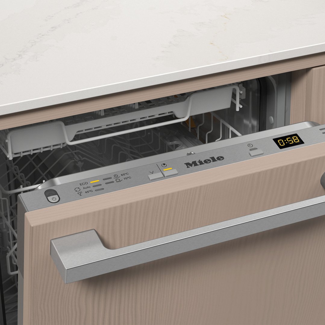 Dishwasher with open door showing control panel and interior racks
