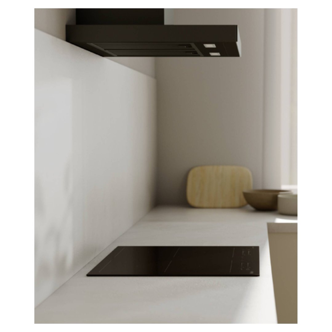 A black induction cooktop integrated into a light kitchen countertop
