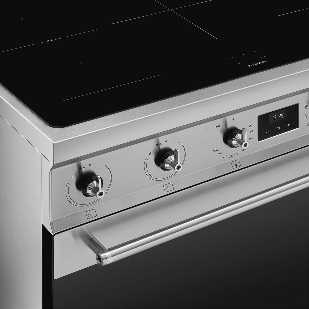 Close-up of a stainless steel freestanding cooker with an induction cooktop