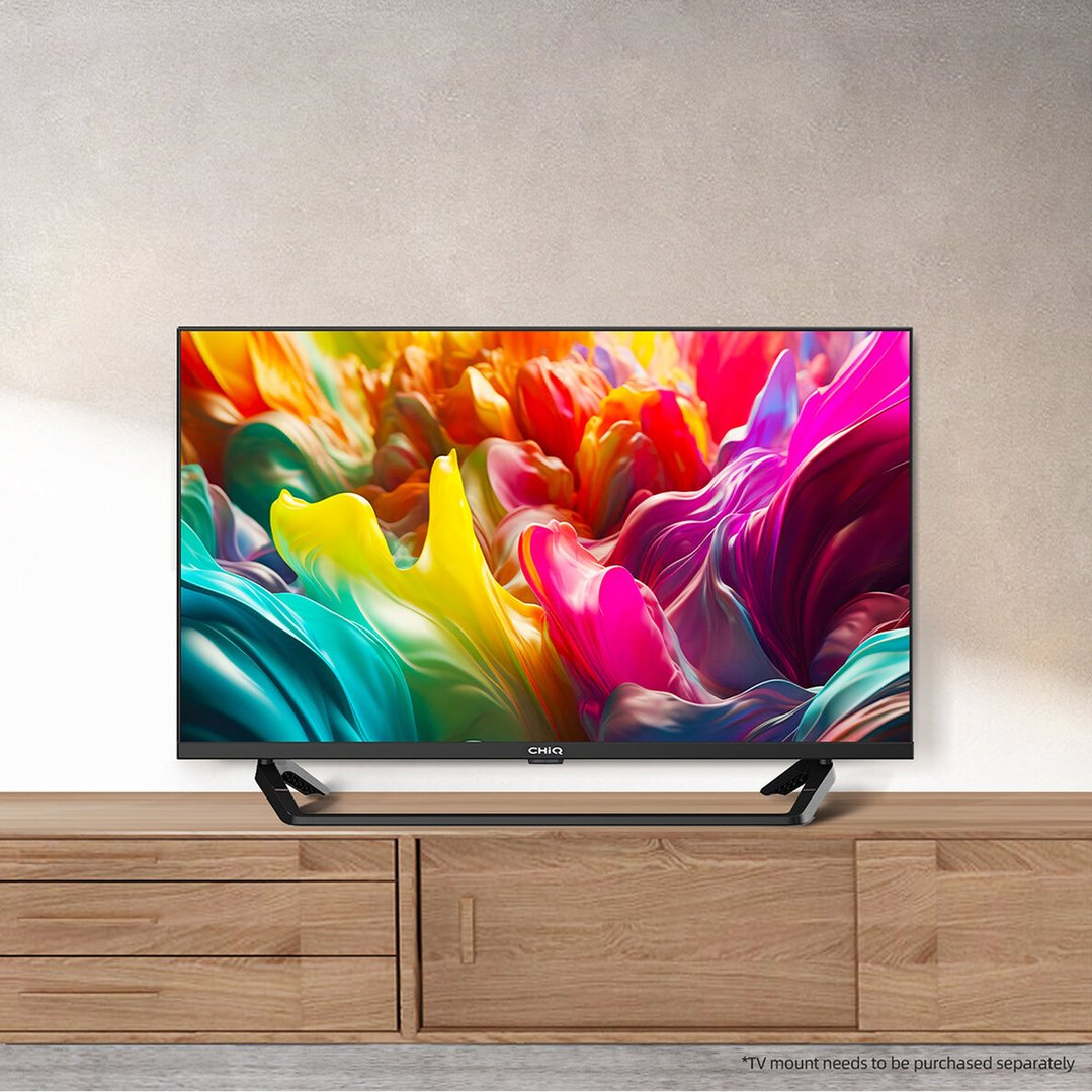 CHIQ TV on a wooden entertainment unit against a textured wall