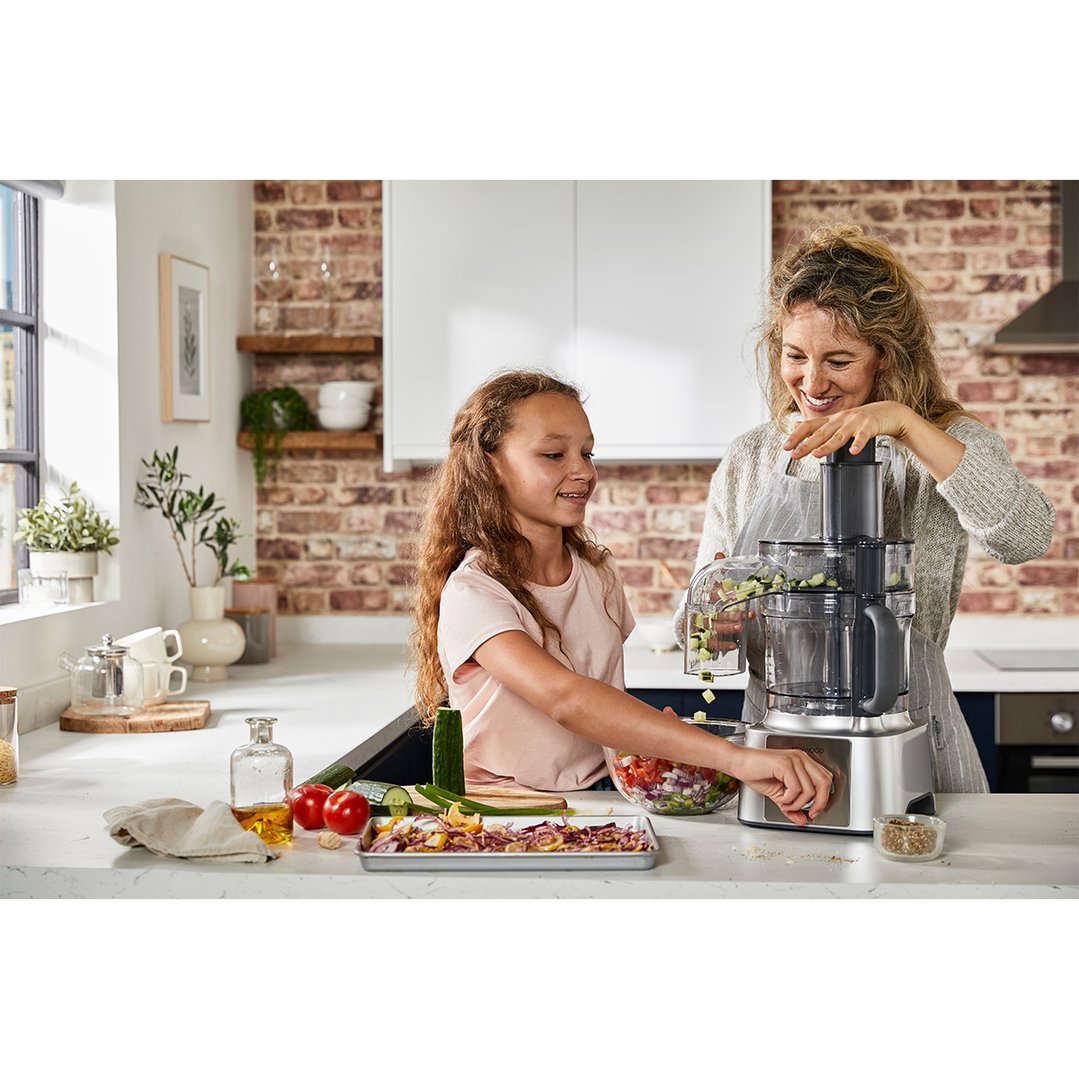 Mother and daughter using a KENWOOD food processor in a kitchen