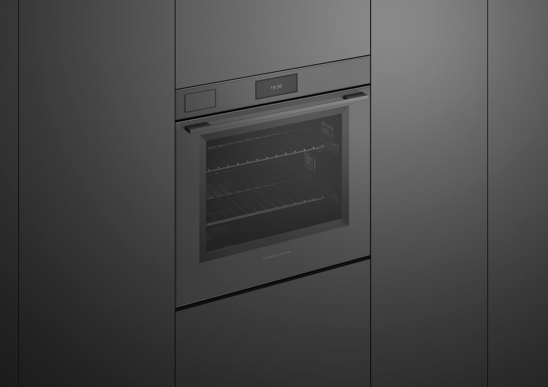 Built-in grey glass oven with digital display showing 19:30 in a dark kitchen