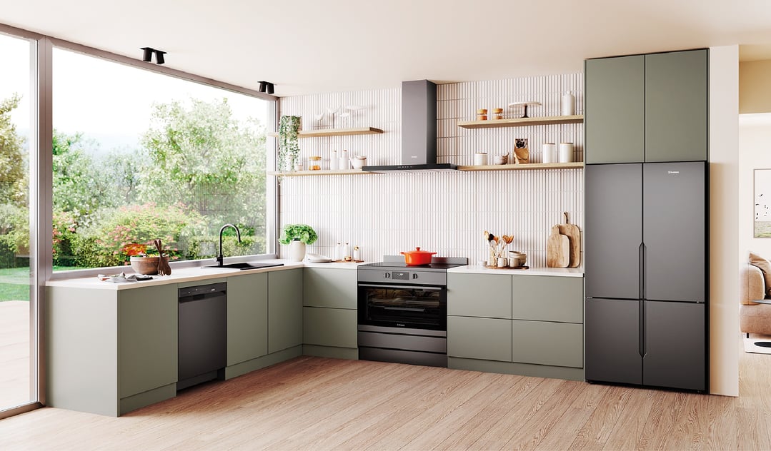 Matte charcoal black quad door fridge in a modern kitchen with large window