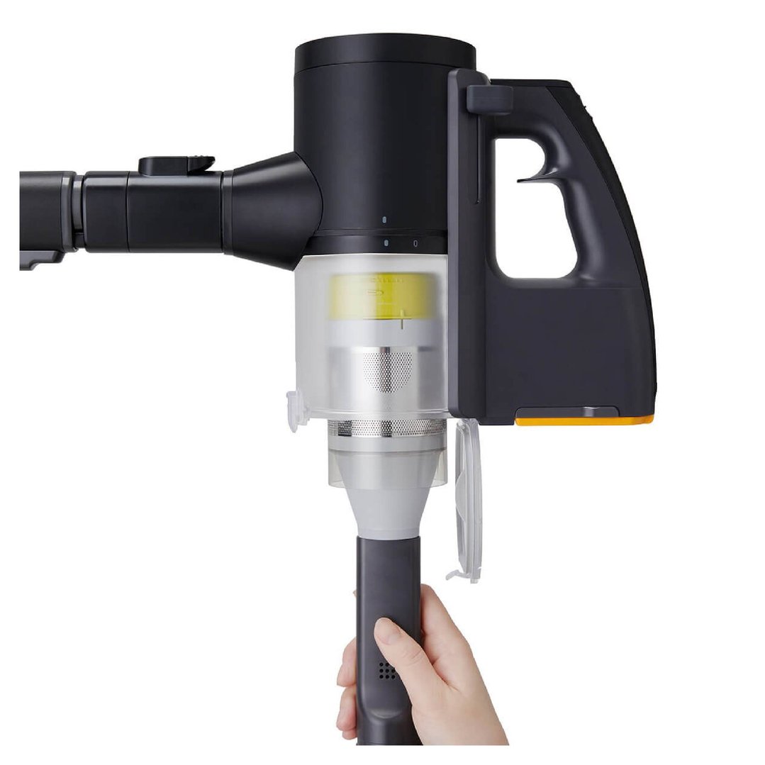 Hand holding the handle of a black CordZero stick vacuum