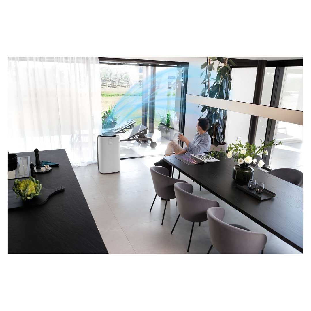 Man relaxing in a modern living space with an air conditioner