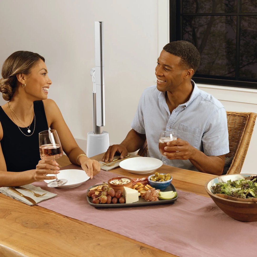 A couple enjoying dinner with the SHARK TurboBlade Fan on the table