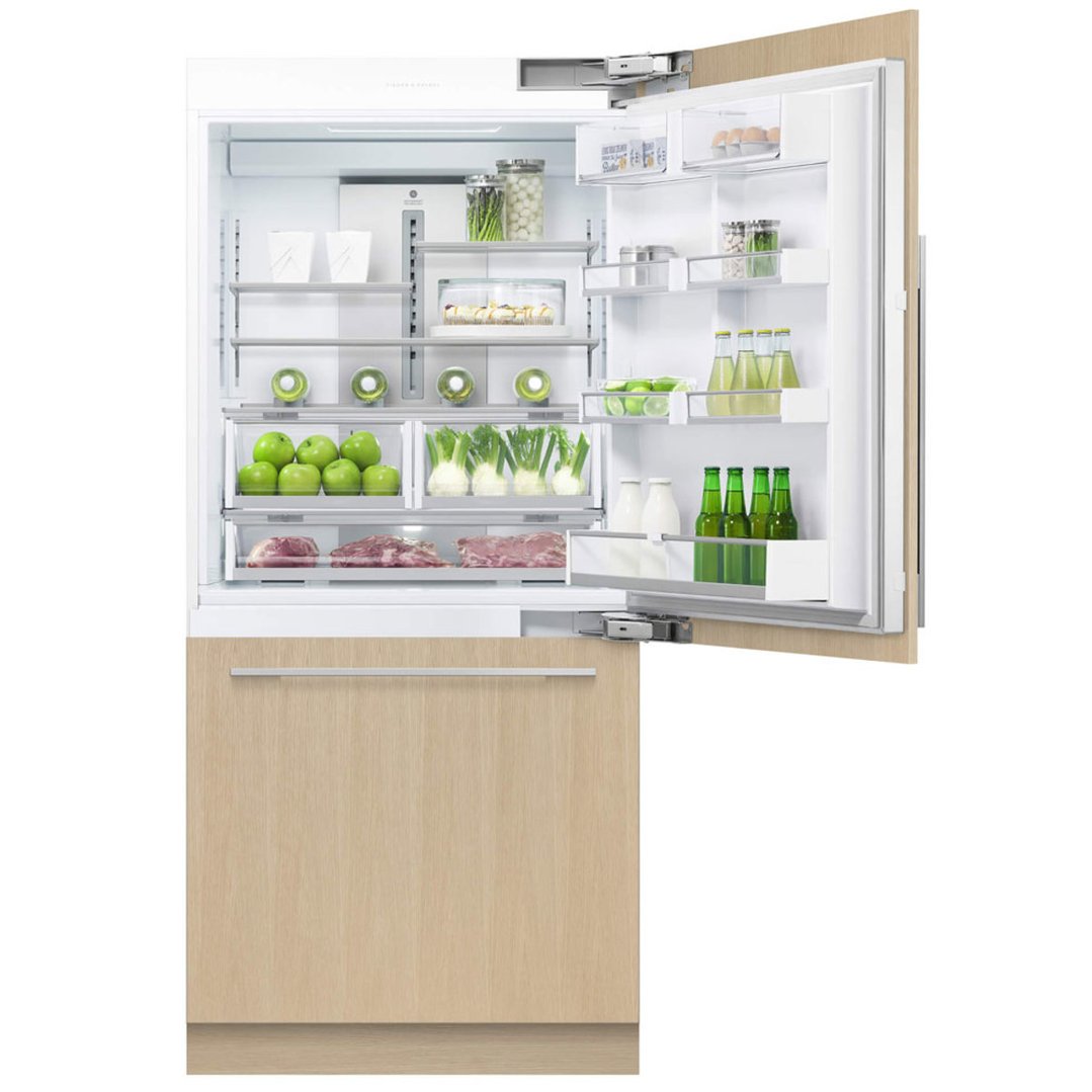 Integrated refrigerator freezer with open door showing food items inside