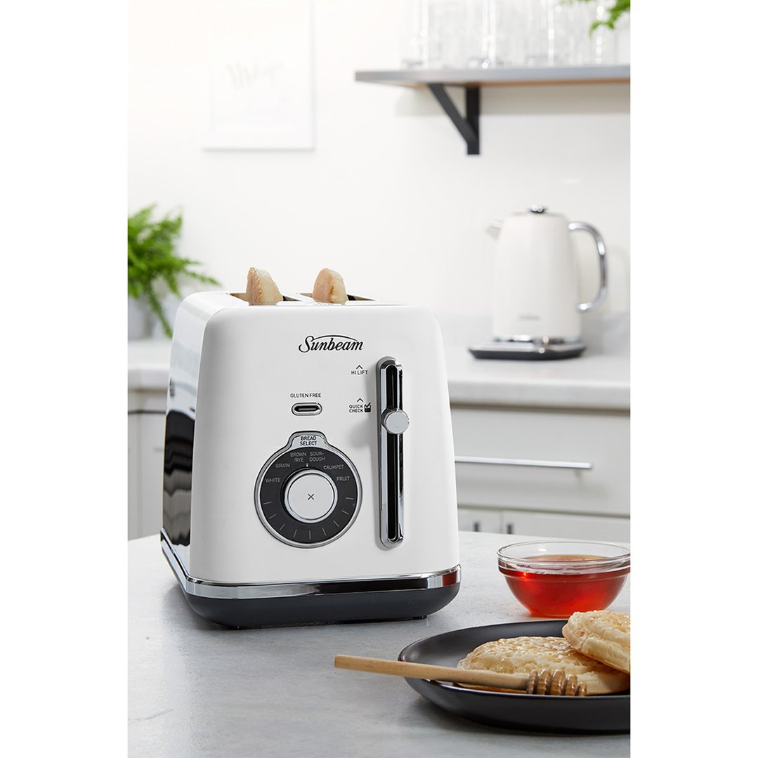 White Sunbeam toaster with toast in a kitchen setting with honey and crumpets