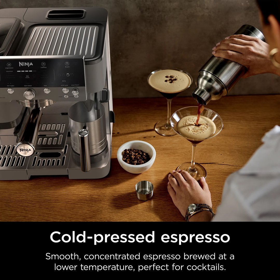 Person pouring cold-pressed espresso from a shaker into a martini glass