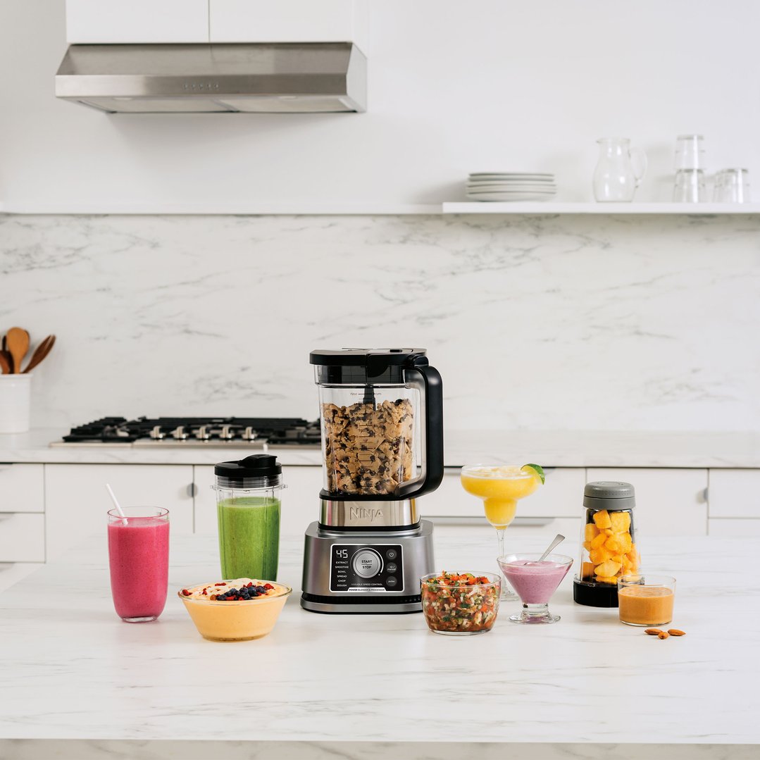 Ninja Foodi Power Blender & Processor System on a kitchen counter with various food items