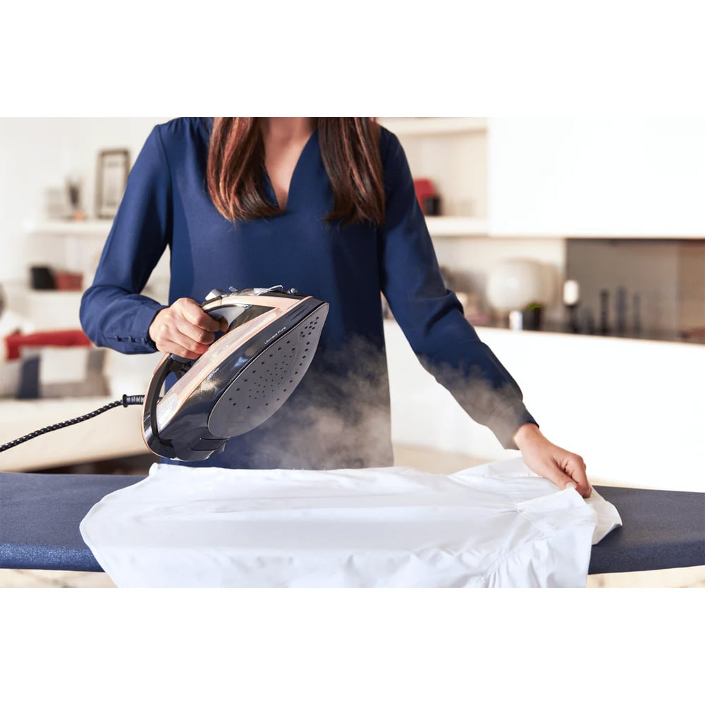 Woman ironing a white shirt with a TEFAL Ultimate Pure Anti-Calc Steam Iron