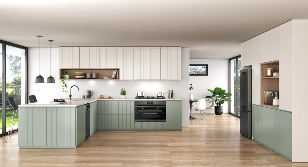 Dark stainless steel oven built into a modern kitchen with light green cabinetry