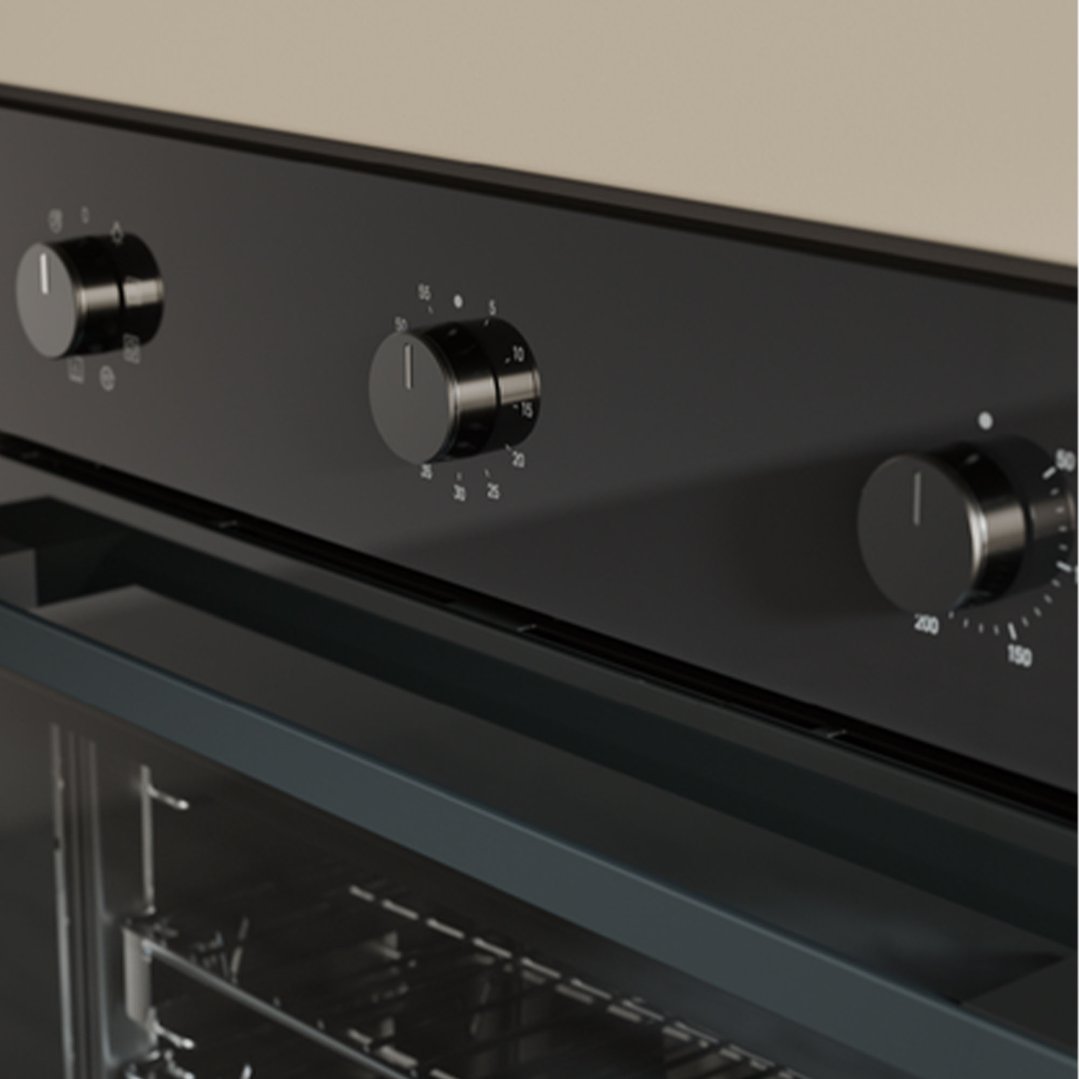 Close up of a black built-in oven with three control knobs