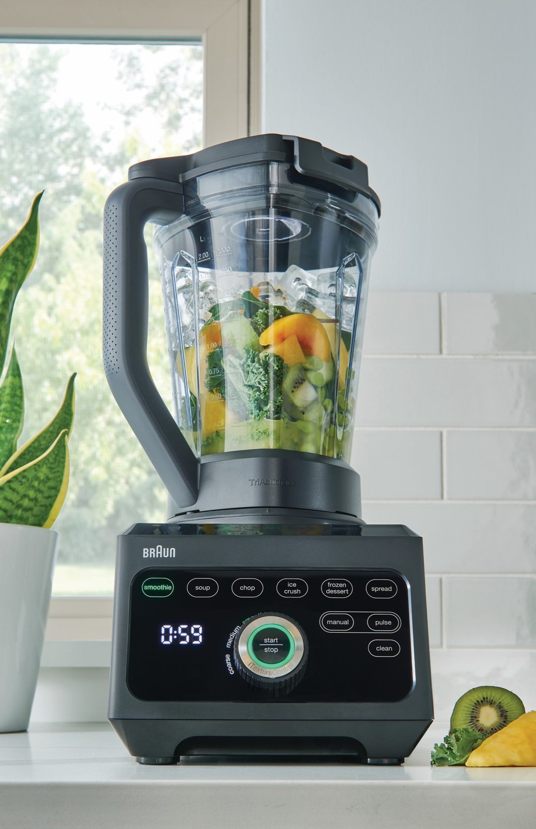 Braun PowerBlend 9 Jug Blender filled with fruit and ice on a kitchen counter