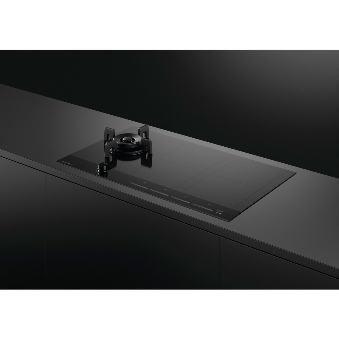 Black hybrid cooktop with one gas burner and four induction zones on a dark countertop