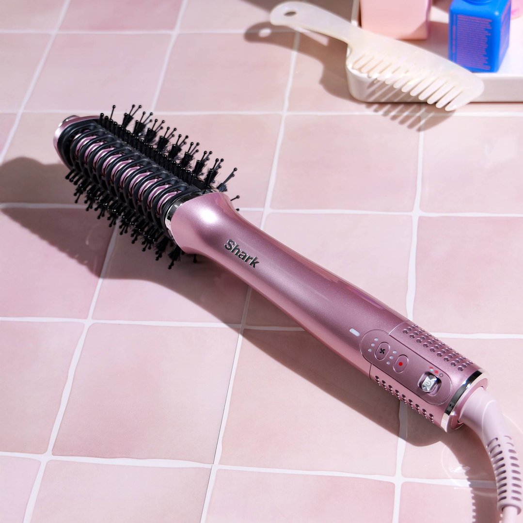Pink Shark 2-in-1 hot tool and air glosser on pink tiled surface