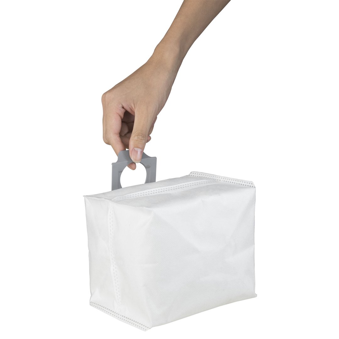 Hand holding a white disposable dust bag for a vacuum cleaner