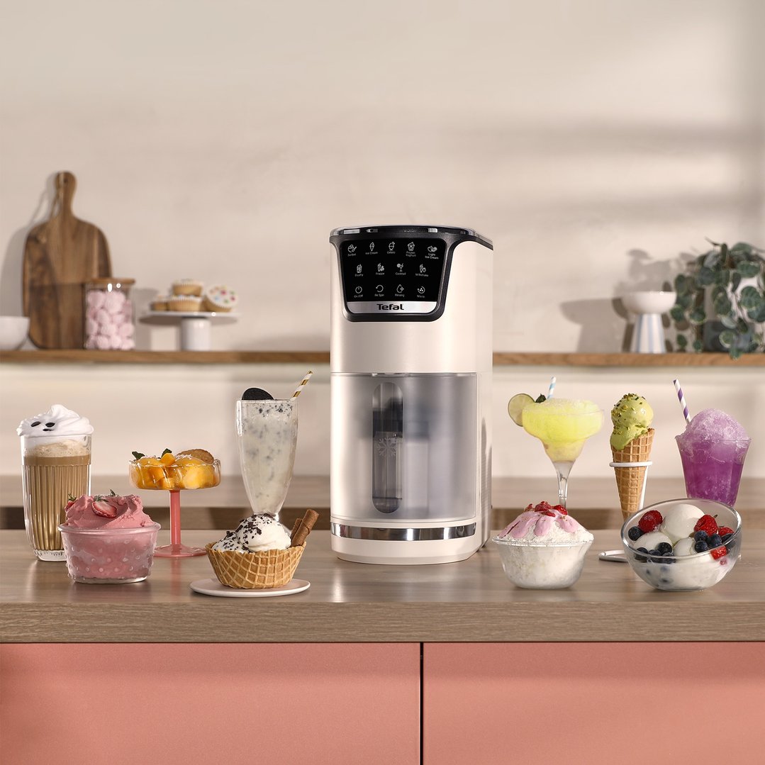 Tefal ice cream maker on a kitchen counter surrounded by various desserts
