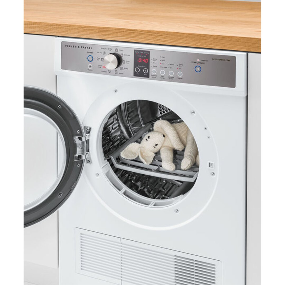 Open Fisher & Paykel 7kg Series 7 Vented Dryer with a knitted toy inside