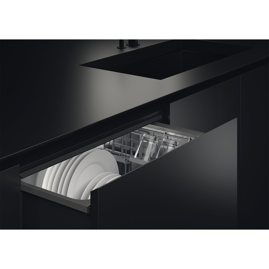 Integrated DishDrawer dishwasher with white plates and clear glasses in a dark kitchen