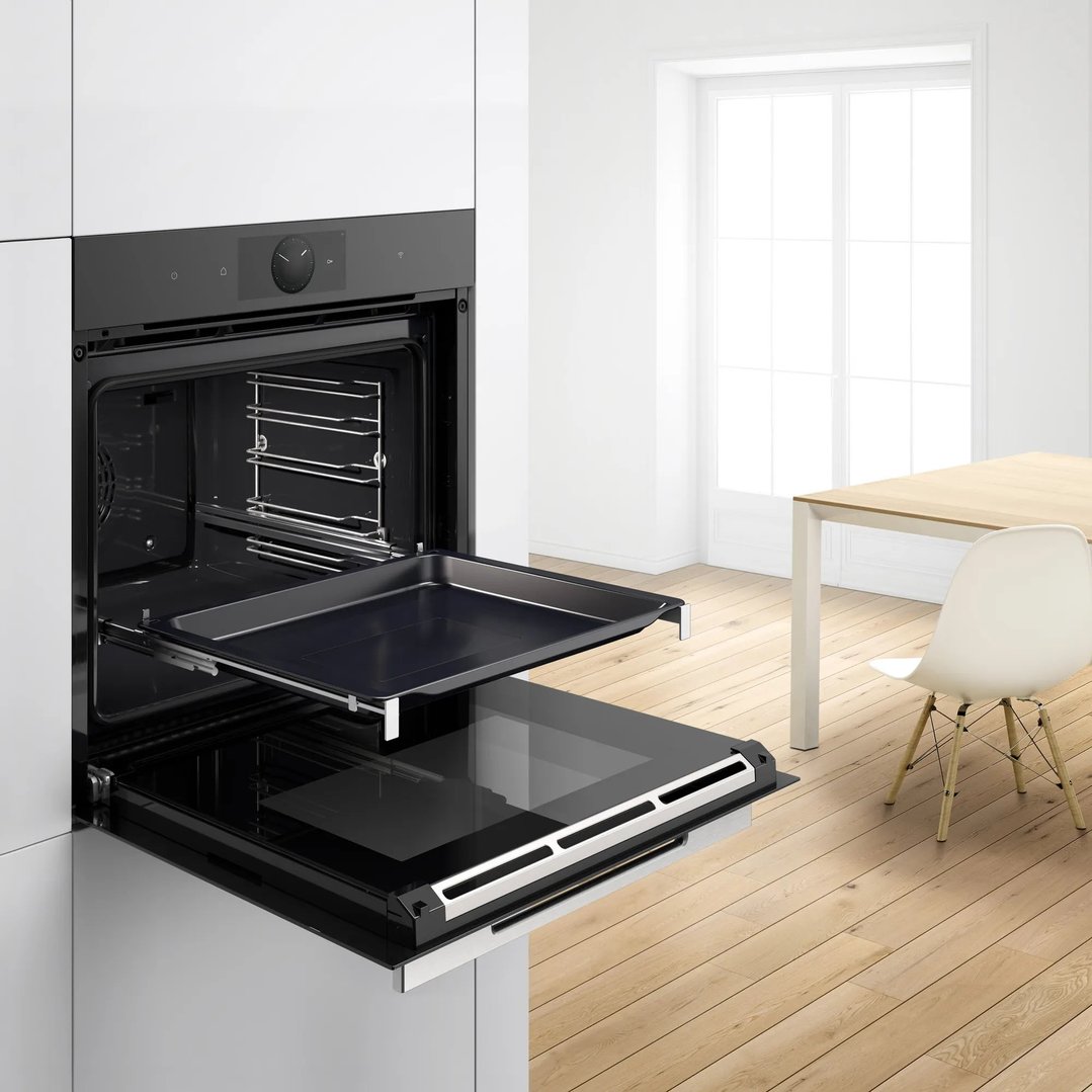 Oven with baking tray pulled out in a modern kitchen setting