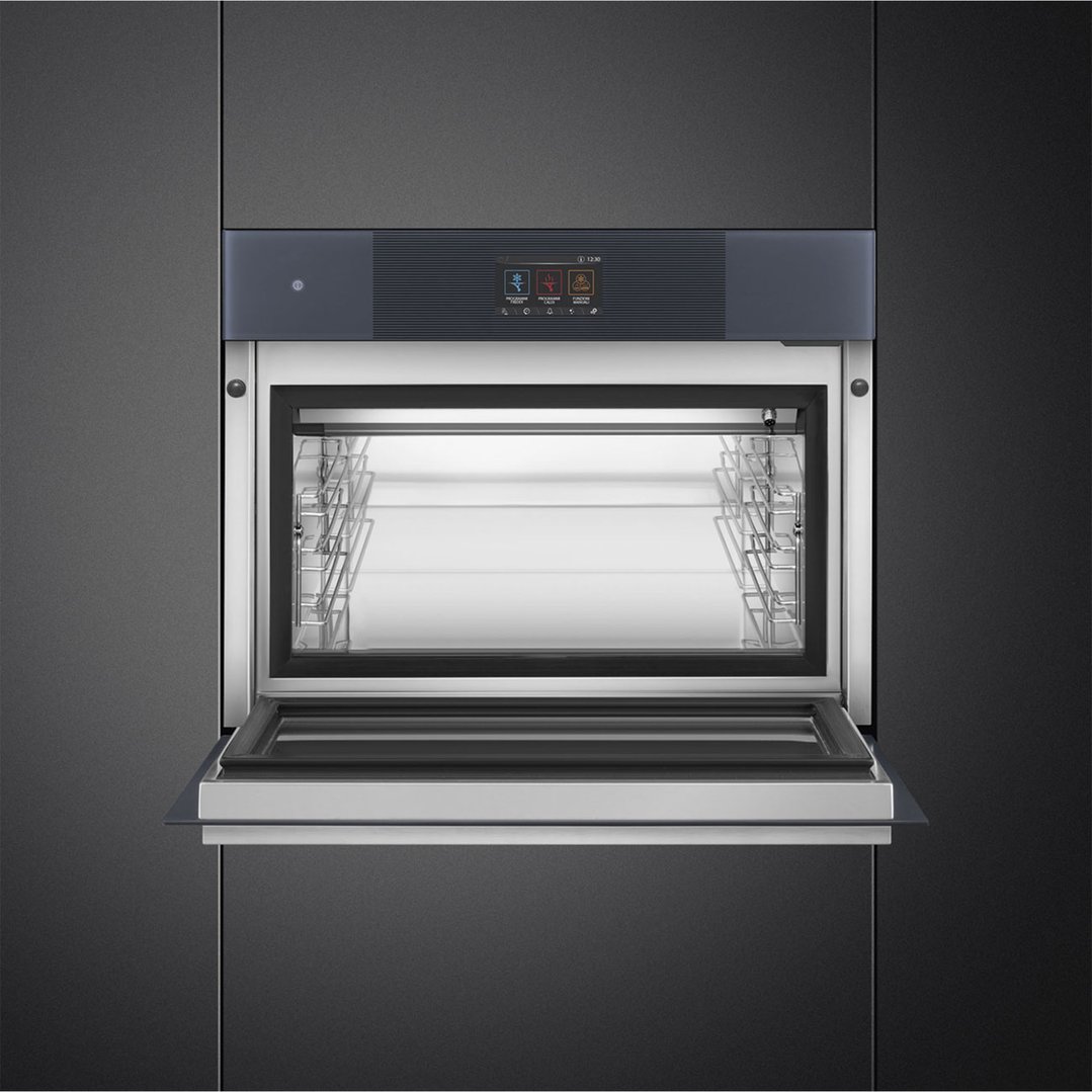 A Linea Compact Blast Chiller with its door open, built into dark cabinetry