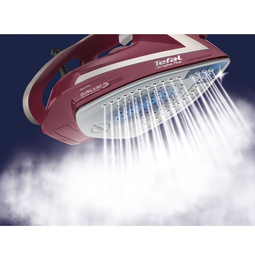 Tefal Ultragliss Anti-Calc Plus steam iron emitting steam against a dark background