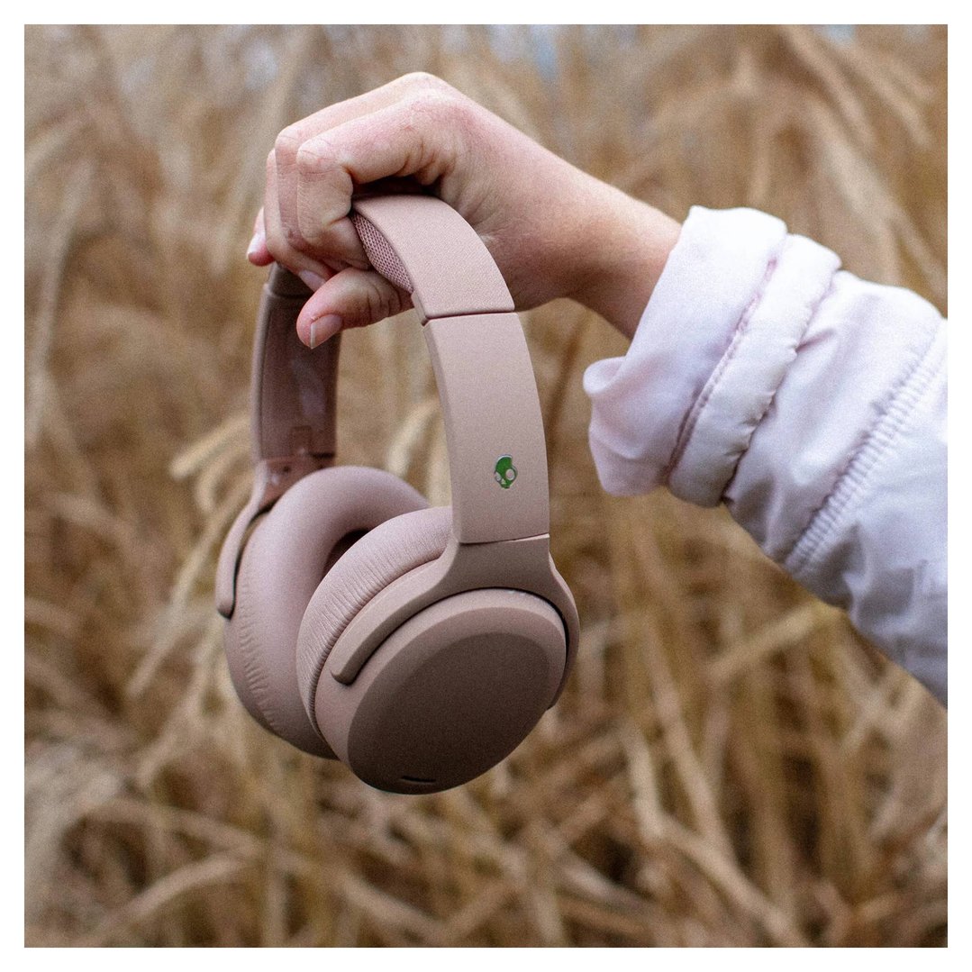 Hand holding a pair of SKULLCANDY Crusher ANC 2 Over-Ear Headphones outdoors