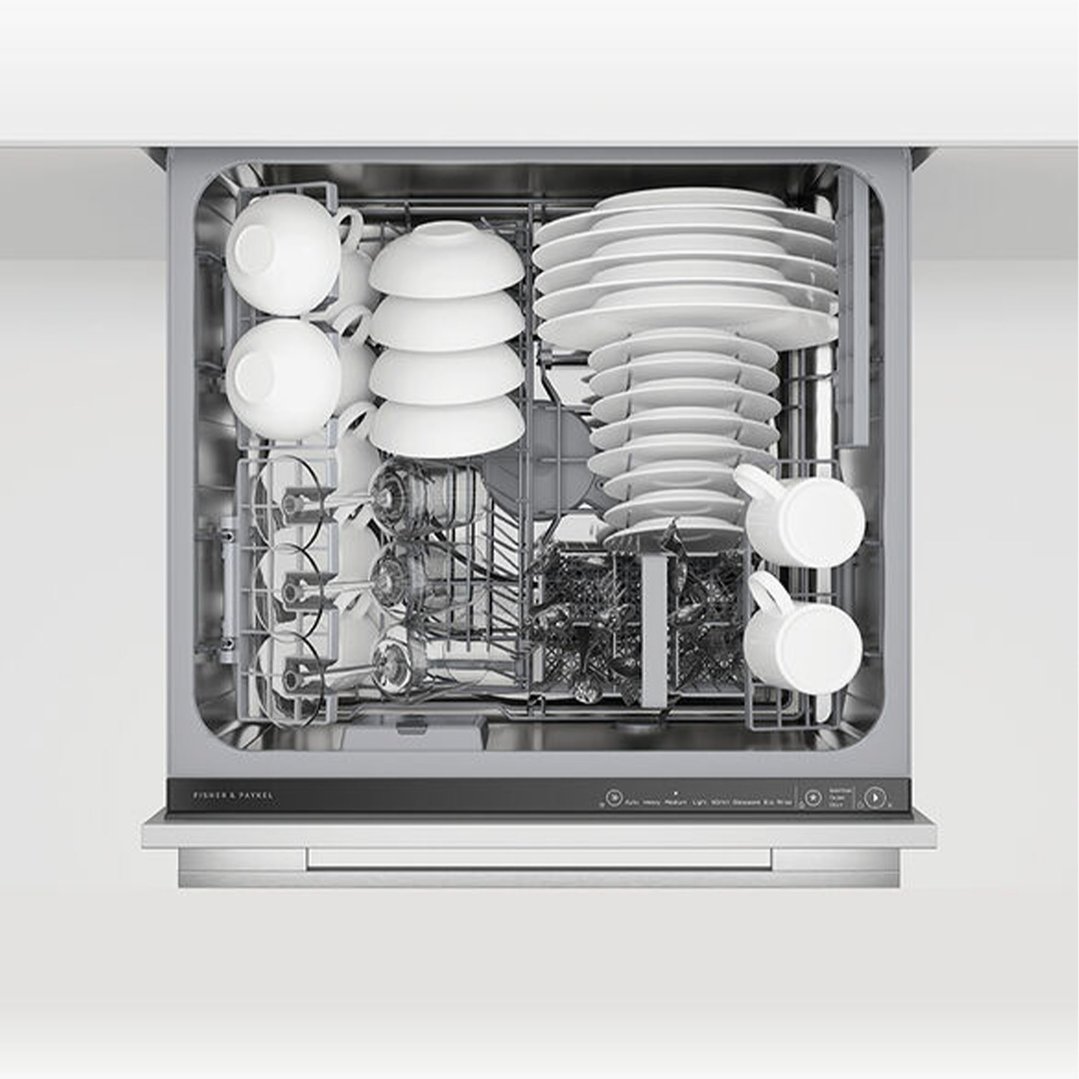 Top drawer of a dishwasher filled with white dishes and glassware