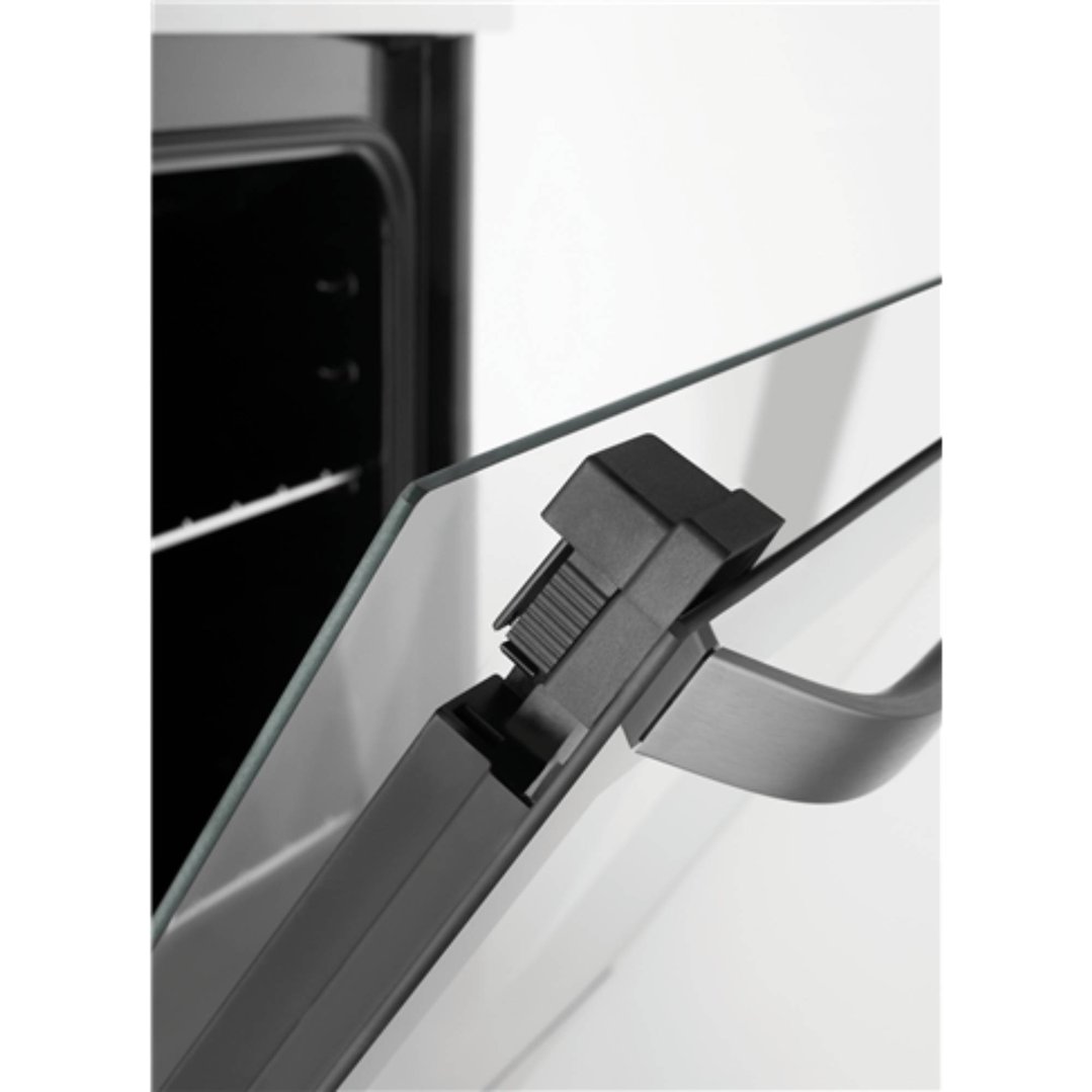 Close up of the oven door of a freestanding cooker, slightly ajar