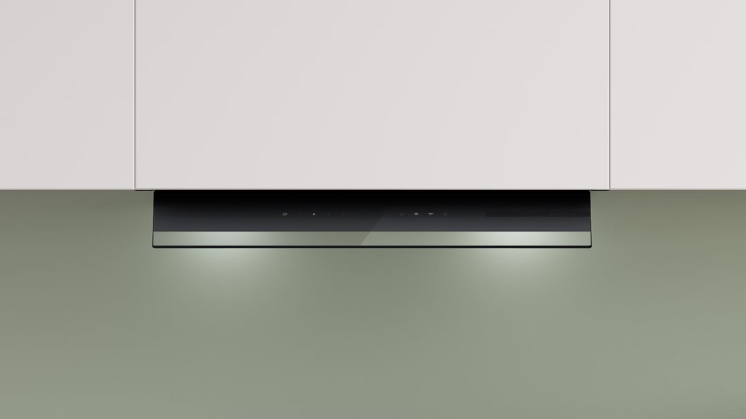 Integrated rangehood with controls and lights, installed under white kitchen cabinets