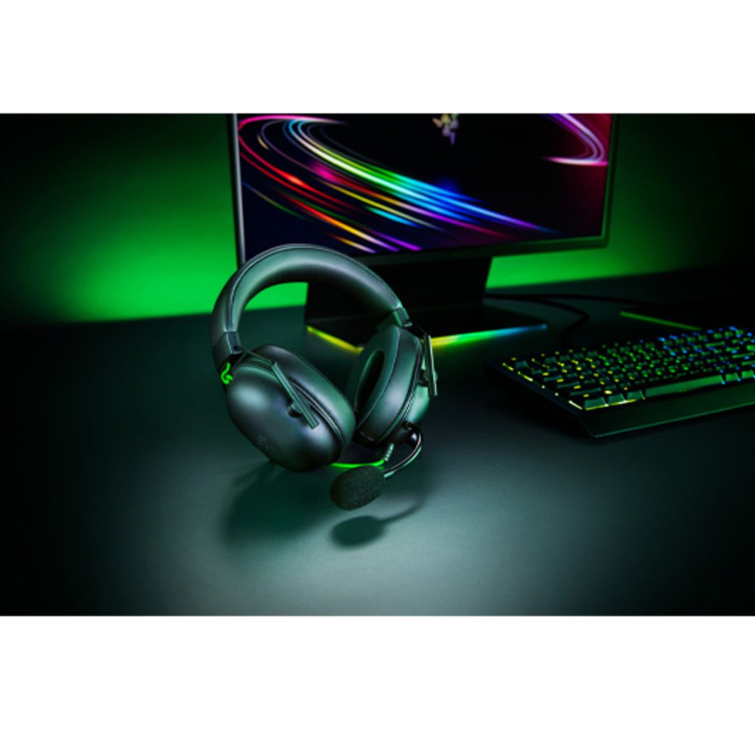 RAZER BlackShark V2 X Headset on a desk with a monitor and keyboard
