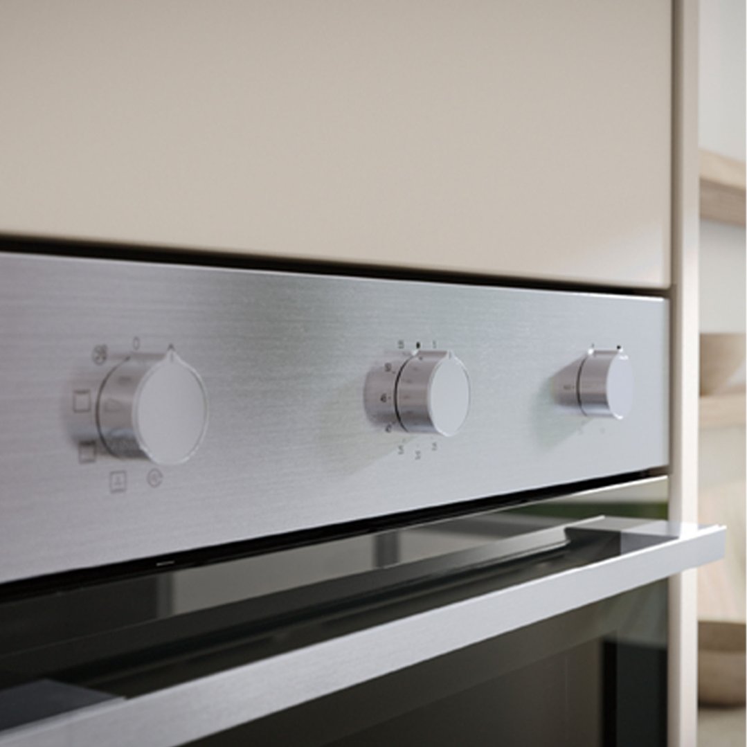 Close up of a built-in oven with control knobs in a kitchen setting