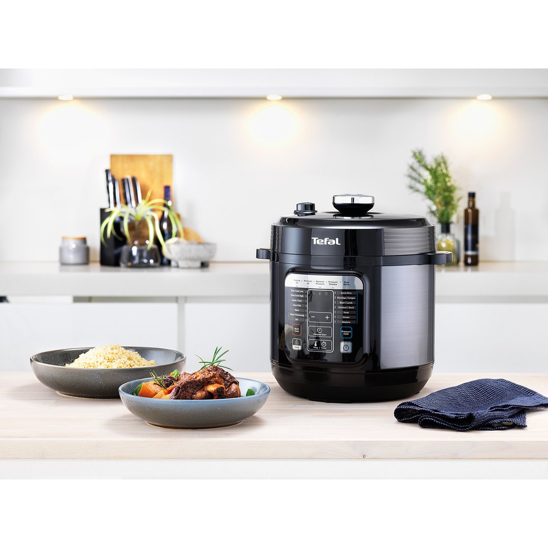Tefal Home Chef Smart Multicooker on a kitchen counter with cooked food