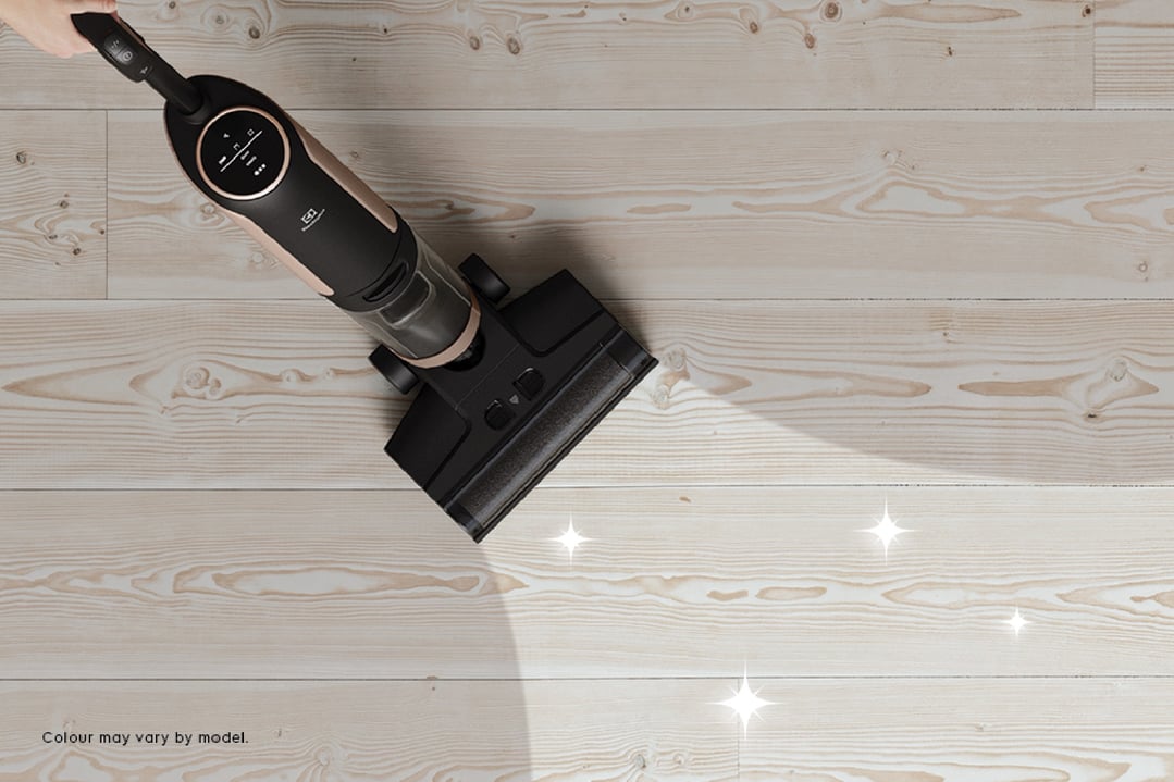 UltimateHome 700 Wet & Dry Vacuum cleaning a light wooden floor, top-down view