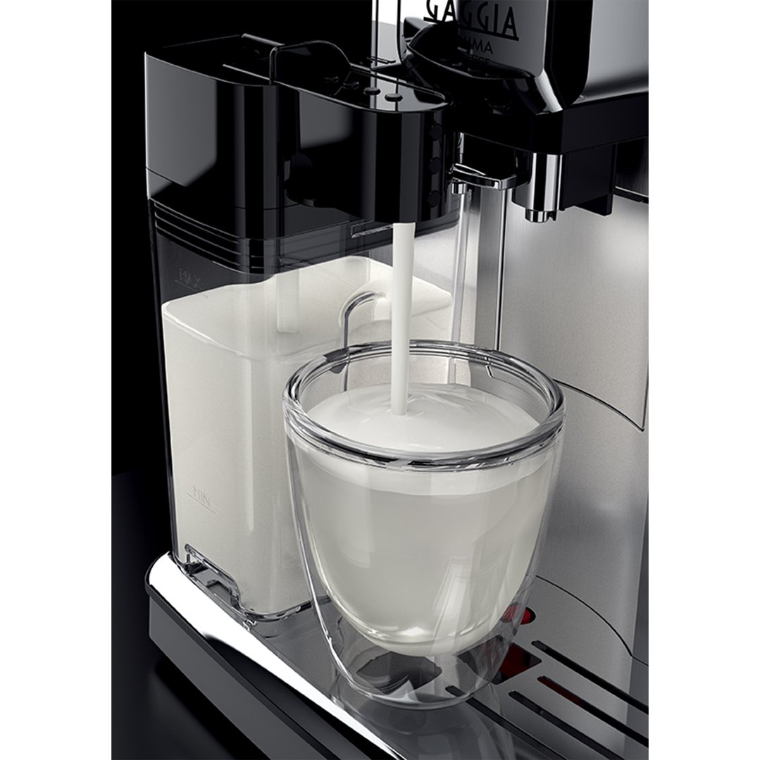 Close-up of a Gaggia coffee machine dispensing milk into a glass