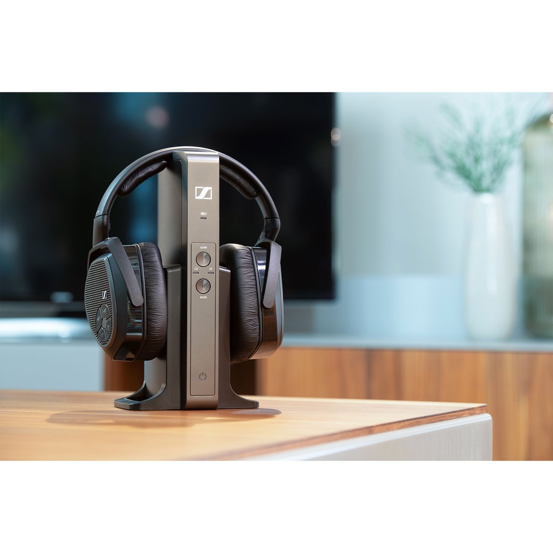 Sennheiser RS 175 TV wireless headphones on a charging dock on a wooden table