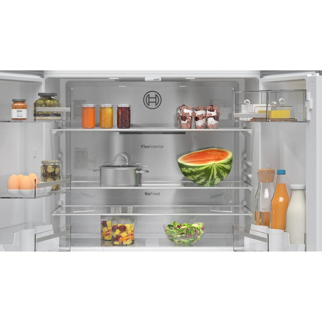 Open Bosch French door bottom freezer fridge interior with food items on shelves