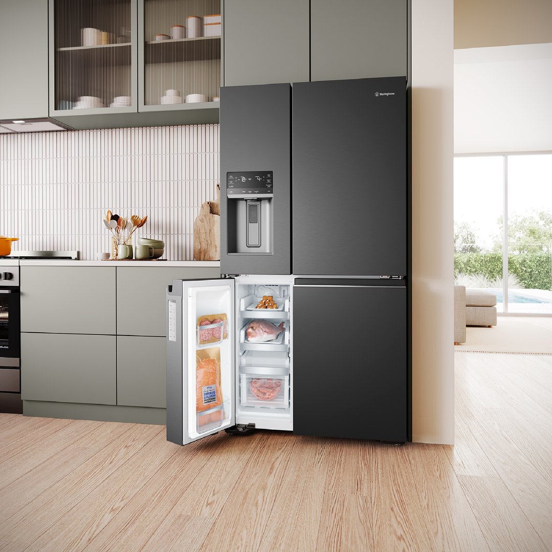 Matte black Westinghouse quad door fridge in a modern kitchen with open freezer door